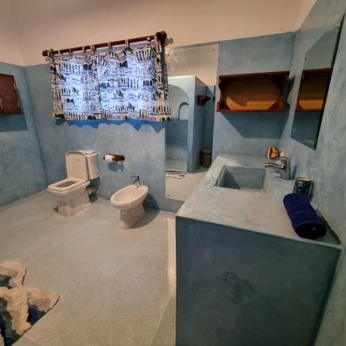 a bathroom with a sink and a toilet at Nyumba Tamu in Watamu