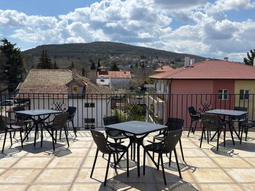 a group of tables and chairs on a patio at Relax Boutique House in Kranevo