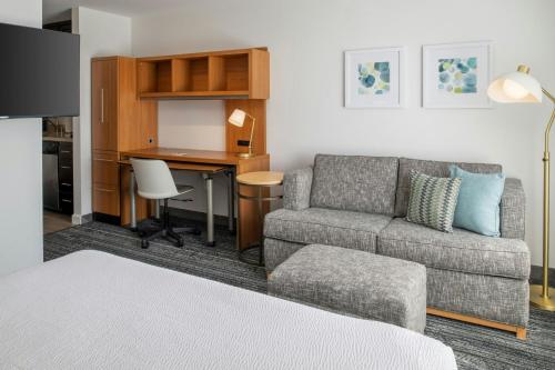 a living room with a couch and a desk at TownePlace Suites Redding in Redding