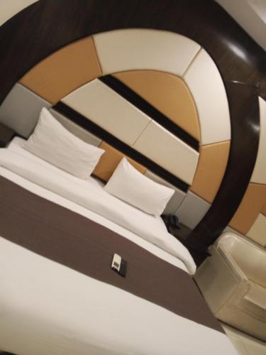 a close up of a bed in an airplane at Fivee Hotel Model Town Multan in Multan