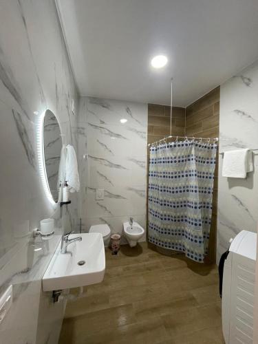 a bathroom with a sink and a toilet and a shower at Enea Apartments 8 in Tirana
