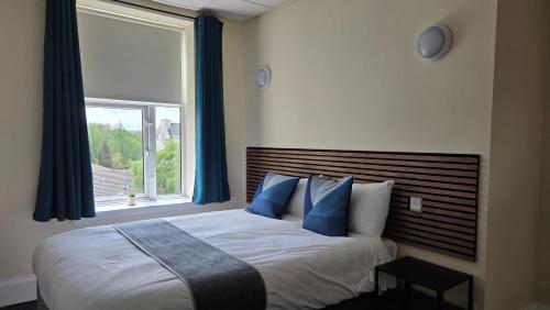 a bedroom with a bed with a large window at The Devonshire House Hotel-Free Parking in Liverpool