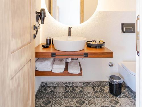 a bathroom with a sink and a mirror at Muyo House in Urla