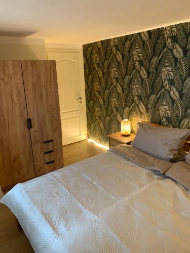 a bedroom with a large bed with a wall mural at Kurzeit 38 in Bad Nenndorf