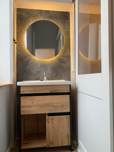 a bathroom with a sink and a mirror at Kurzeit 38 in Bad Nenndorf
