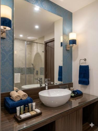 a bathroom with a large sink and a tub at Hotel Banana Tree & Banquets 5 Min From Anand Vihar Bus Terminal and Vaishali Metro Station in Ghaziabad