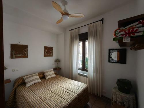 a bedroom with a bed and a ceiling fan at El Herrador in Nájera