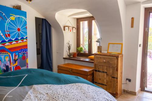 a bedroom with a bed and a wheel on the wall at Borgata Giostra in Caprie