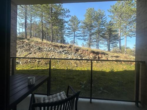 a balcony with a view of a field and trees at Apartman Eden Divčibare in Divčibare