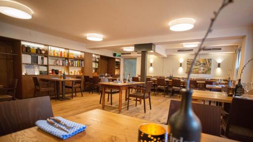 a restaurant with tables and chairs in a room at Hueber der Wirt in Sankt Georgen an der Leys