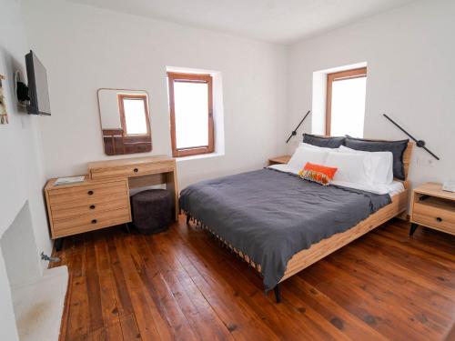 a bedroom with a bed and a dresser and a mirror at Muyo House in Urla