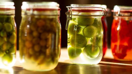 a group of jars of pickles on a table at Hueber der Wirt in Sankt Georgen an der Leys