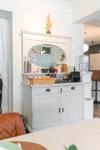 a white dresser with a mirror in a room at B&B Castellier in Lier