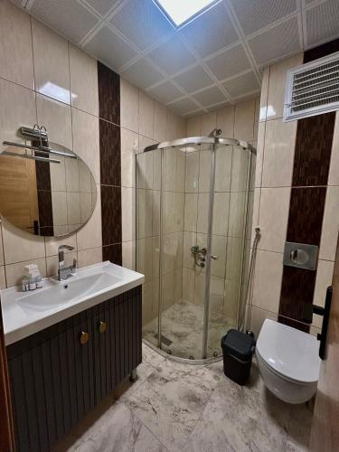 a bathroom with a shower and a sink and a toilet at Akpinar Hotel in Uzungöl