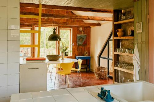 a kitchen with a table and a dining room at 1899 Loft In Creative Gylsboda in Lönsboda