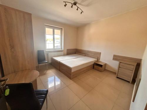 a small bedroom with a bed and a window at Hostel Jagiellońska in Nowe Miasto Lubawskie