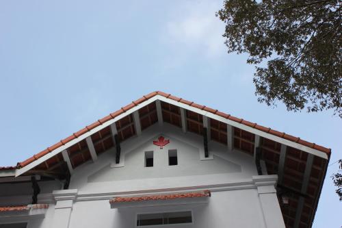 a building with a red cross on top of it at Huy Trung Homestay in Bắc Hà