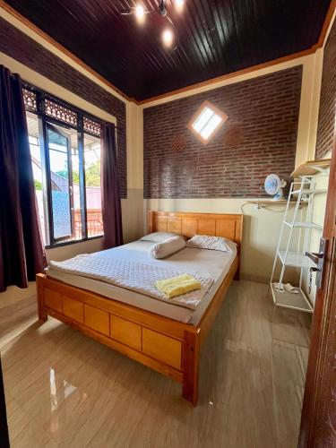 a bedroom with a bed with a ladder in it at Toraja Bungin Family House in Rantepao