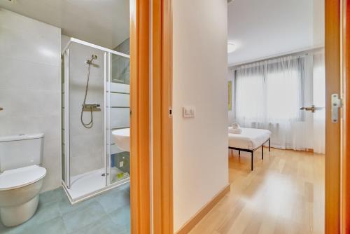 a bathroom with a shower and a toilet and a sink at Las Gaunas by Clabao in Logroño
