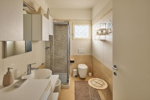 a bathroom with a sink and a shower at Badesi Sea Dunes in Codaruina