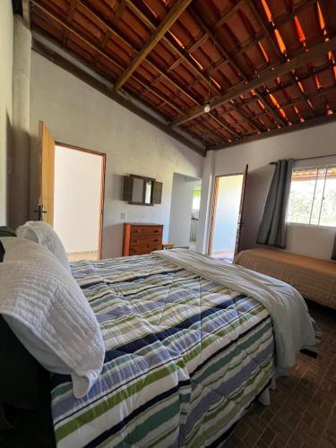 a bedroom with a large bed in a room at Chales Estiva Nova in Mucugê