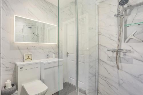 a bathroom with a shower and a toilet and a sink at 2 Bed in Snape oc-12sf in Snape