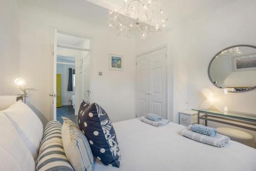 a room with a bed with pillows and a mirror at 2 Bed in Snape oc-12sf in Snape