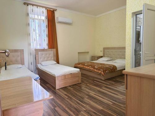 a hotel room with two beds and a window at Mirage in Shinuhayr