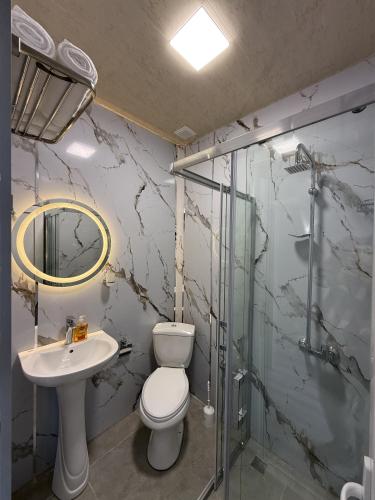 a bathroom with a toilet and a sink and a shower at Miva in Qusar