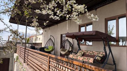 a balcony with two chairs and a umbrella at Syunyats guest house in Halidzor