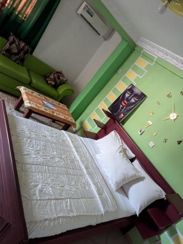 a bedroom with a bed and a table and a couch at BALI HOTEl in Yaoundé