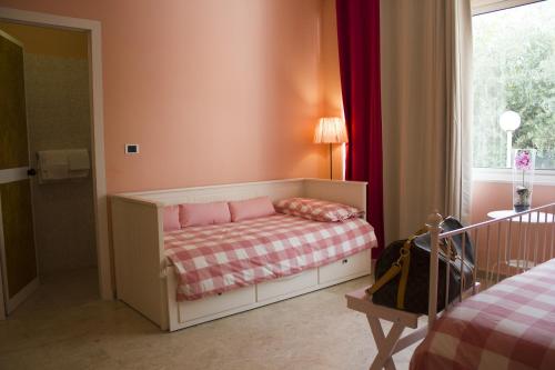 a small bedroom with a bed and a window at Hotel La Maison Delle Terme in Tivoli Terme