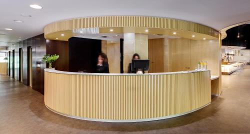 a lobby with a reception desk in a building at Sercotel Gran Hotel Zurbarán in Badajoz