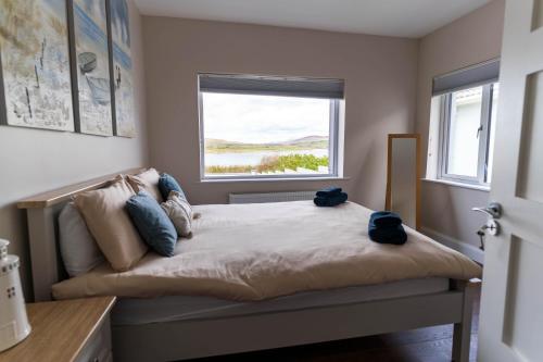 a bedroom with a bed with a window at Renard Haven - Cahersiveen in Cahersiveen