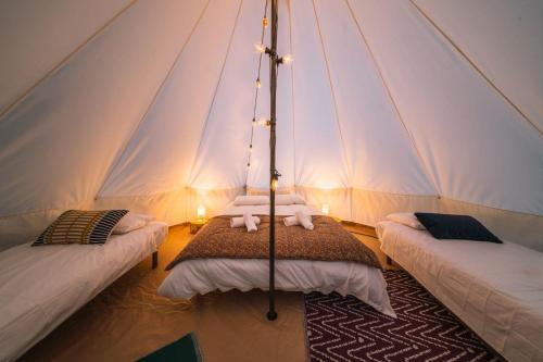 a room with two beds in a tent at Campement Ô Rêves in Genouilleux