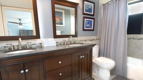 a bathroom with a sink and a toilet and a mirror at 305 Kawama Tower in Key Largo