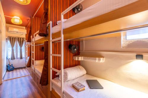a room with three bunk beds and a laptop at Madpackers Varanasi in Varanasi