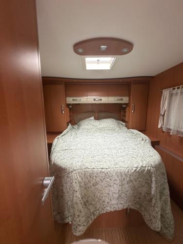 a bedroom with a bed in a small room at Camping car Paris in Savigny-le-Temple