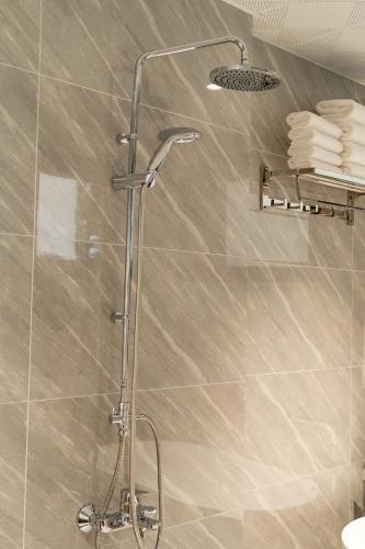 a shower with a glass door in a bathroom at Tam Cốc Hà Anh Hotel in Văn Lâm