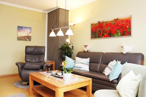 a living room with a couch and a table at Ferienwohnung Heuer in Ebstorf
