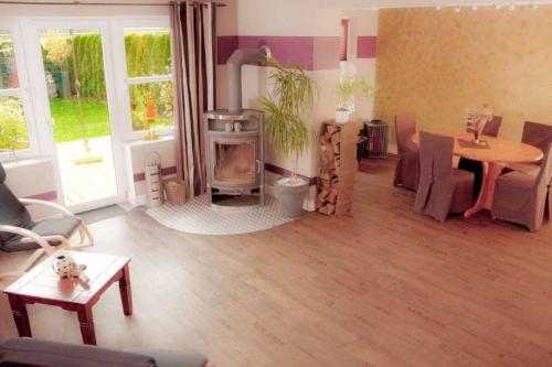 a living room with a wood stove and a table at Haus Sonnenschein in Dänschendorf
