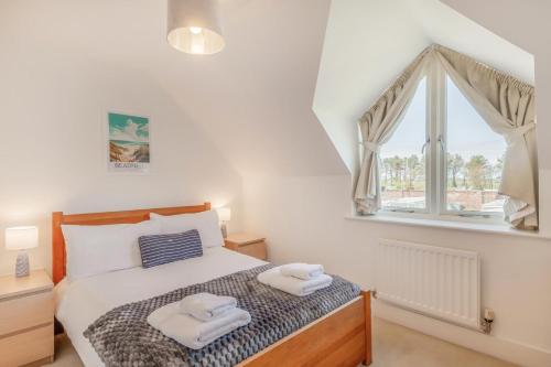 a bedroom with a bed with two towels on it at 3 Bed in Chathill oc-61892 in Beadnell