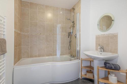 a bathroom with a tub and a sink at 3 Bed in Chathill oc-61892 in Beadnell