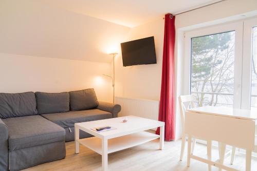 a living room with a couch and a table at Schleiblick App 18 in Rabenkirchen-Faulück