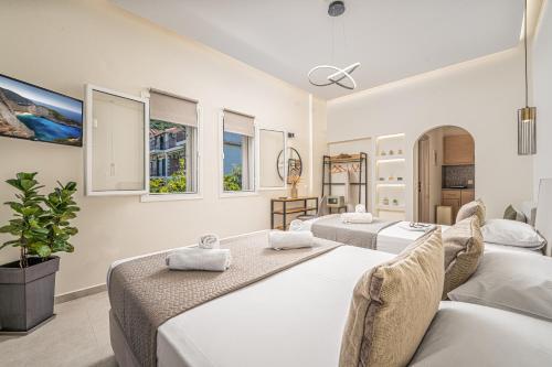 a room with three beds and windows at Villa Dionysios in Keri