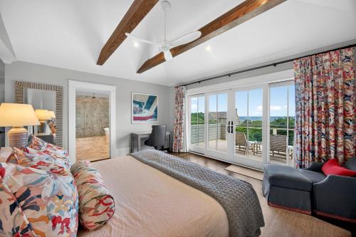 a bedroom with a bed and a couch and a window at SS59: 59 Surfsong in Kiawah Island