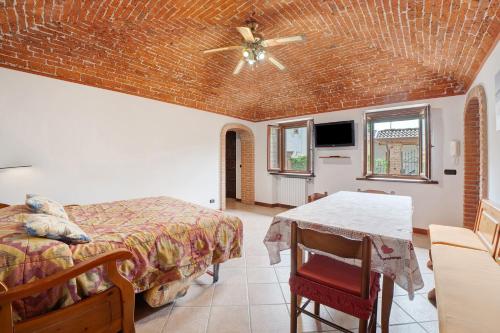 a bedroom with a bed and a ceiling fan at Centenario Affittacamere in Fara Novarese