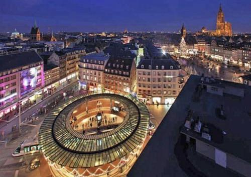 a view of a city at night at L'escale - proche Homme de Fer in Strasbourg