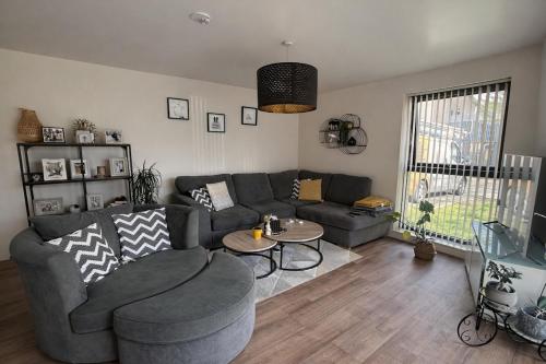 a living room with a couch and a table at Elegant 2-Bed 2-Bath Flat in Edinburgh in Edinburgh