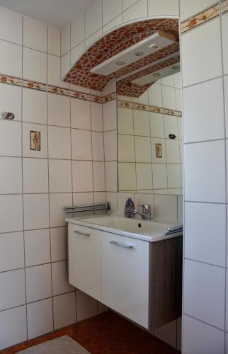 a bathroom with a sink and a mirror at Biohof Weissensteiner in Ullrichs